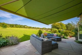 Green awning overlooking sunny garden